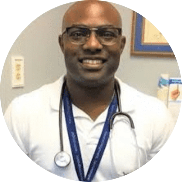 Thomas Hinton, a black man with a shaved head wearing glasses, a stethoscope, and a white polo shirt.