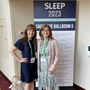 Amy Clifton and Julie Flygare pose for a photo at SLEEP 2023.